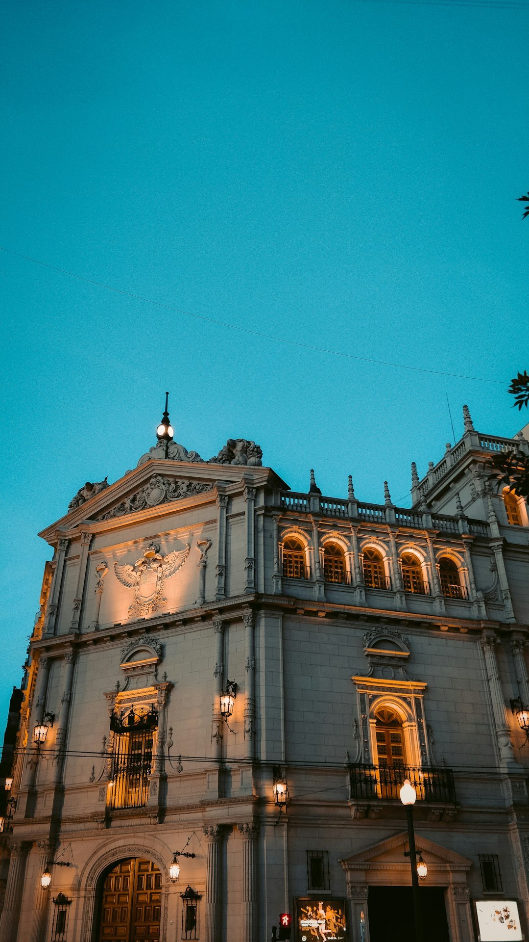 Elegant Buenos Aires theatre facade at dusk with warm golden light