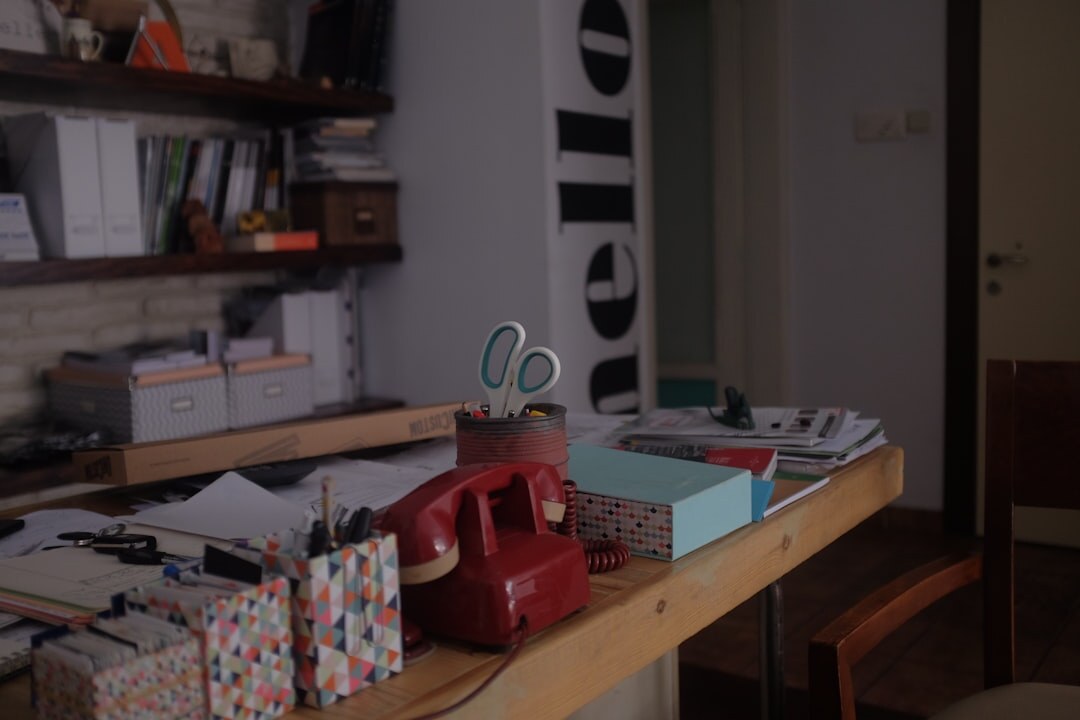 Design studio table with sketches, fabric swatches and a lamp in warm light