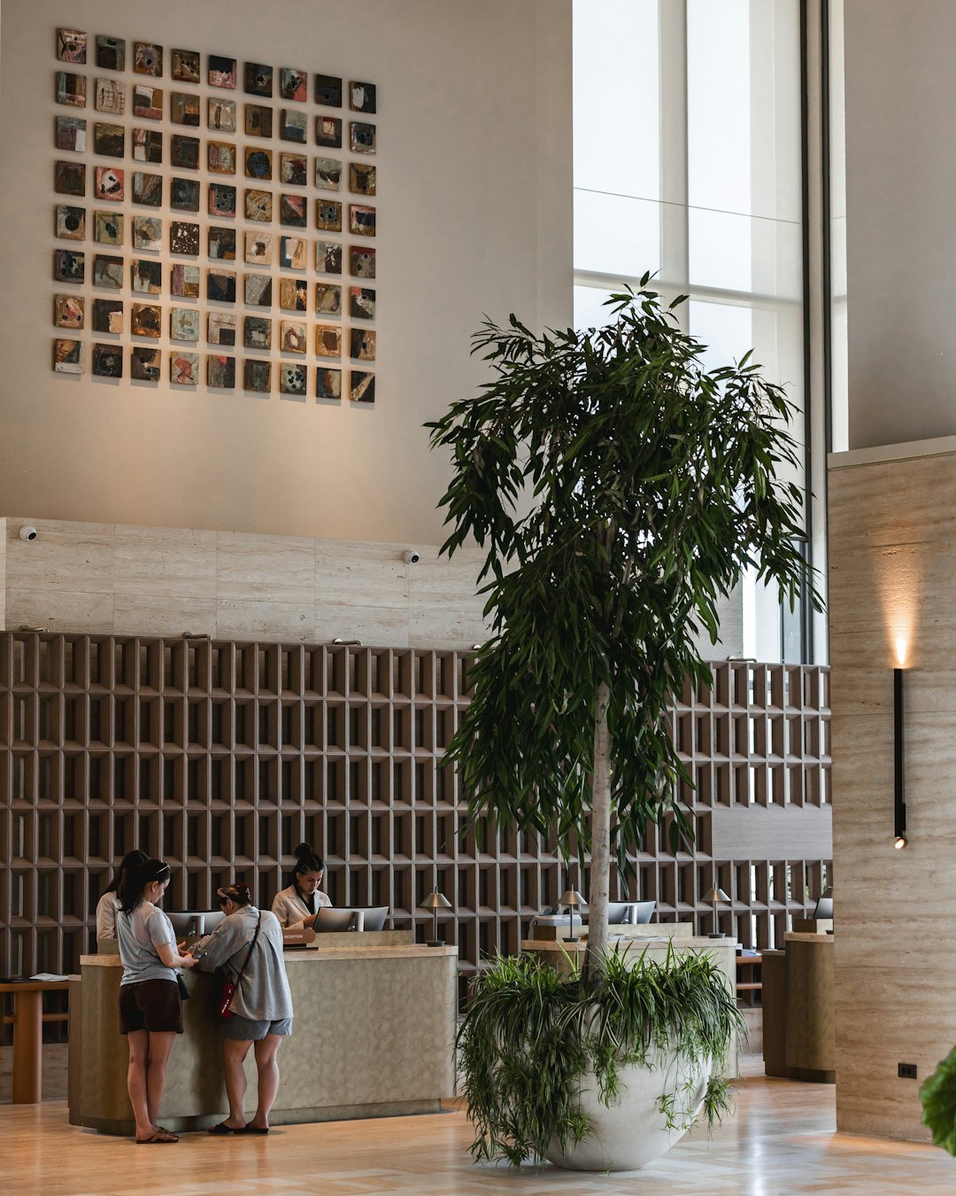 Editorial reception desk with a brass lamp and orchid in a Buenos Aires office