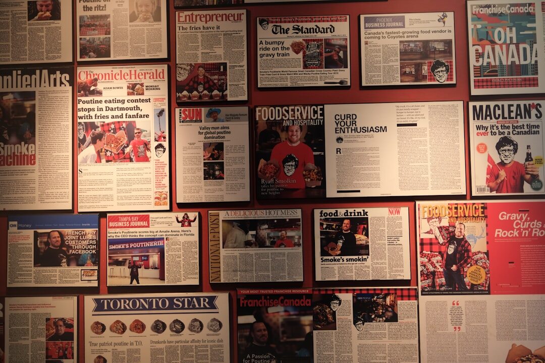 Rows of magazine proofs pinned to a cork board